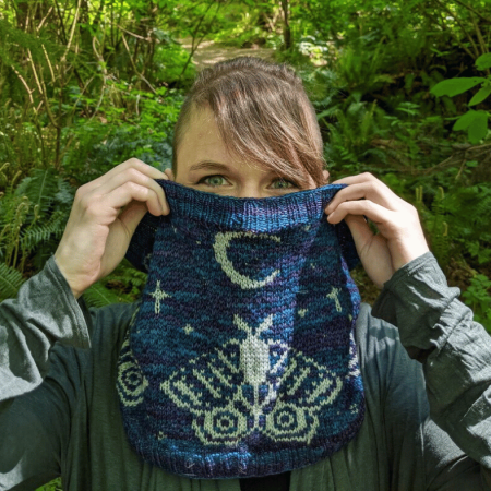 Lucia Blackwell holding a knitted scarf in front of her face