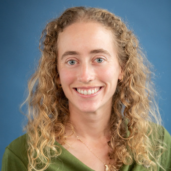 Larissa Kunz headshot. Image of woman with blonde curly hair and green shirt.